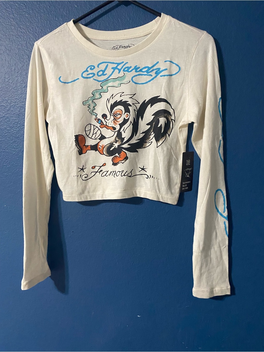 Ed Hardy Cream Long Sleeve Crop Top with Blue Script and Skunk Graphic